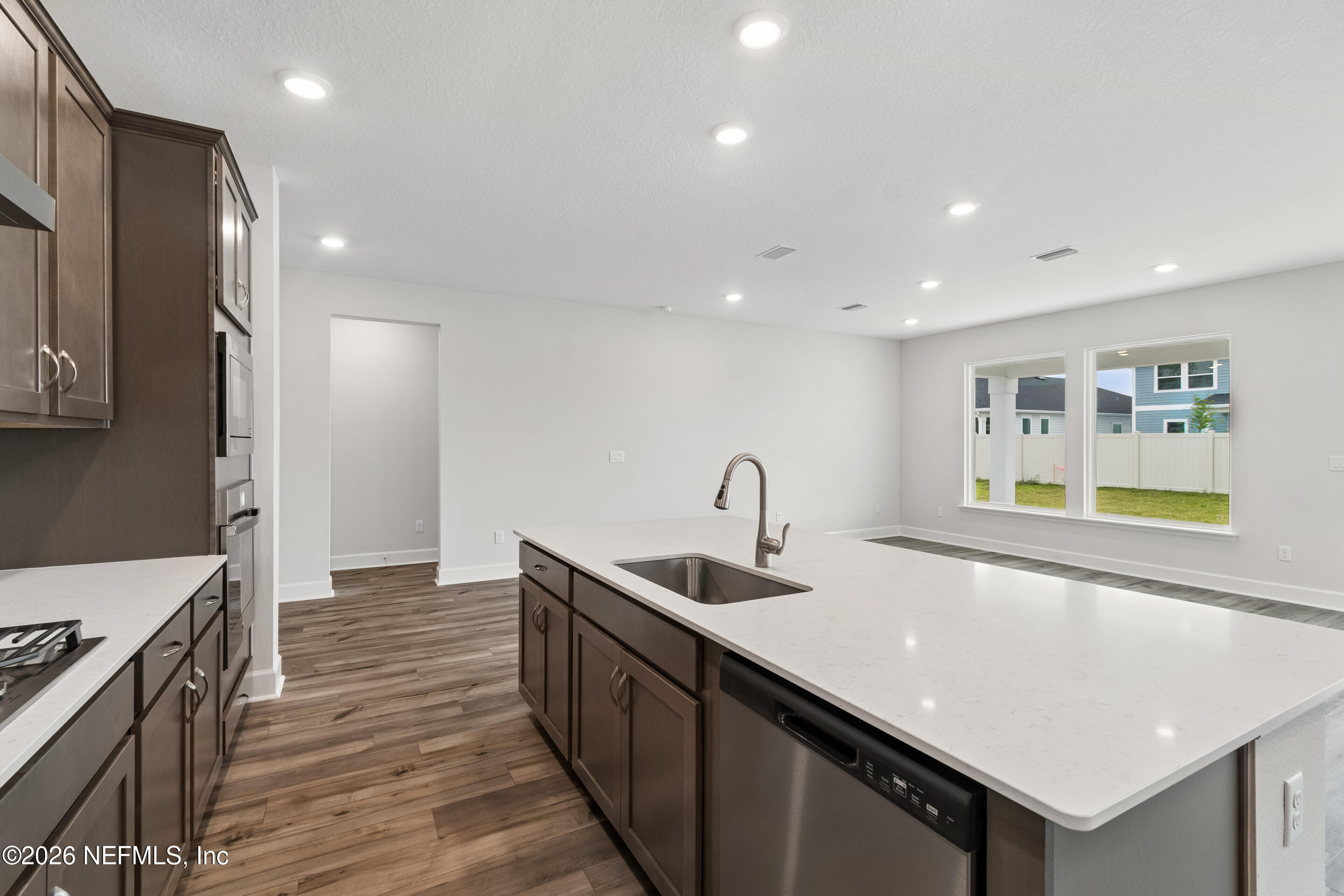 75751 Bayley Place Yulee, FL 32097 - Photo 5 of 28 a kitchen with stainless steel appliances granite countertop a sink a stove and a refrigerator