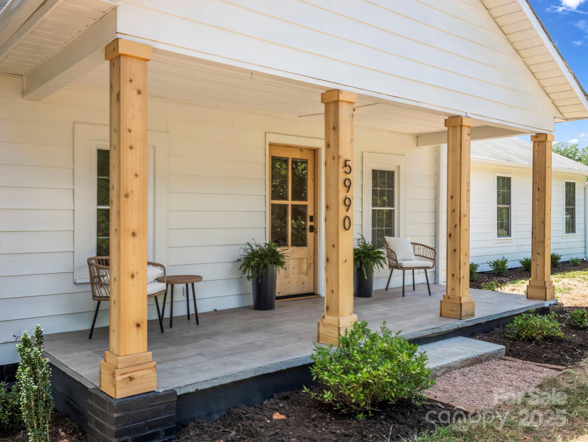 a view of living room filled with furniture and flowers