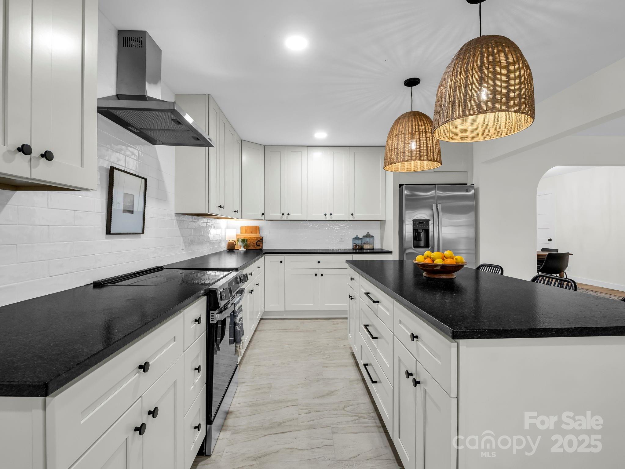 5990 South Nc 9 Highway Tryon, NC 28782 - Photo 15 of 42 a kitchen with granite countertop a sink dishwasher a stove and a refrigerator