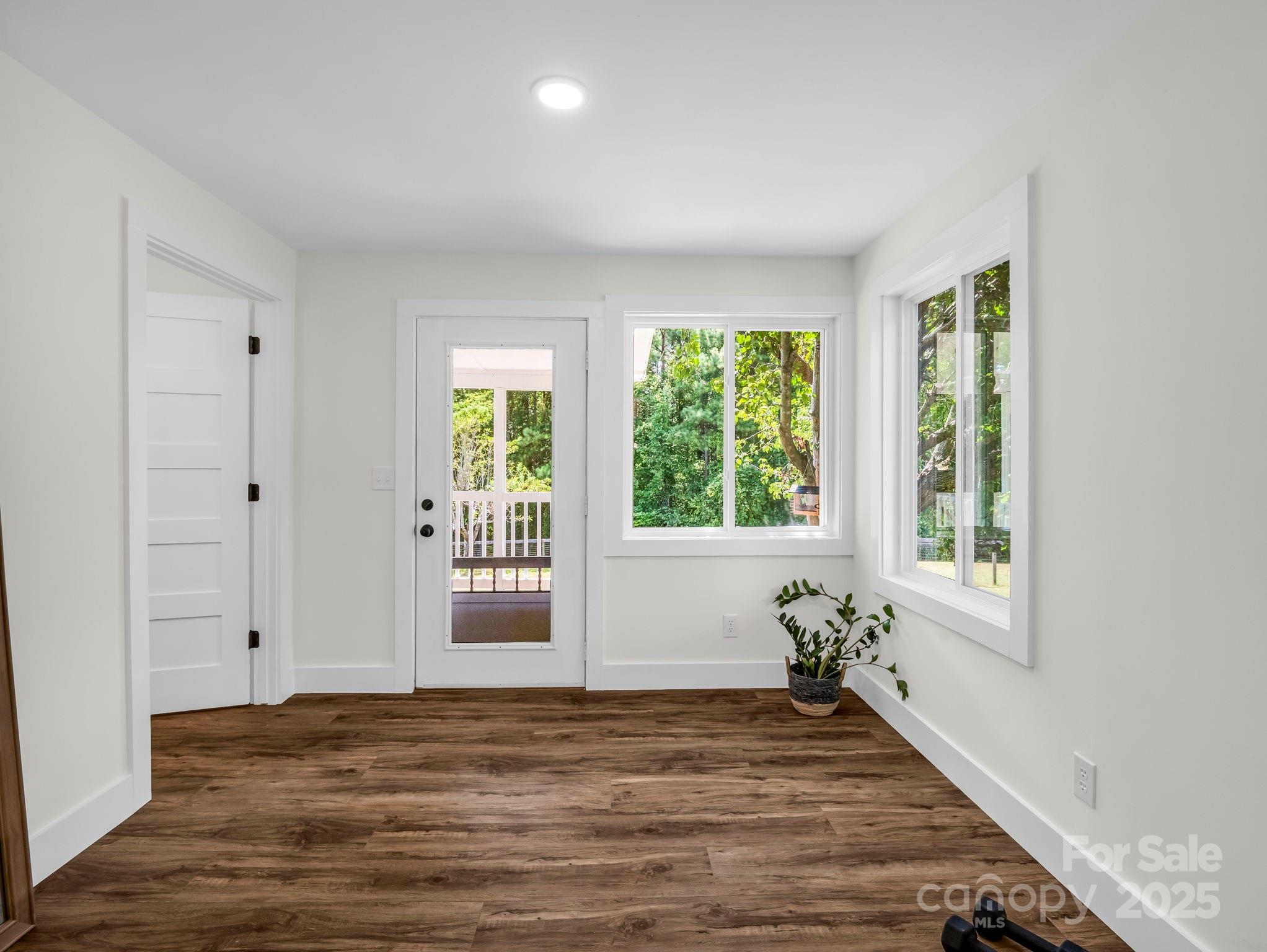 5990 South Nc 9 Highway Tryon, NC 28782 - Photo 26 of 42 a view of an empty room with wooden floor and a window