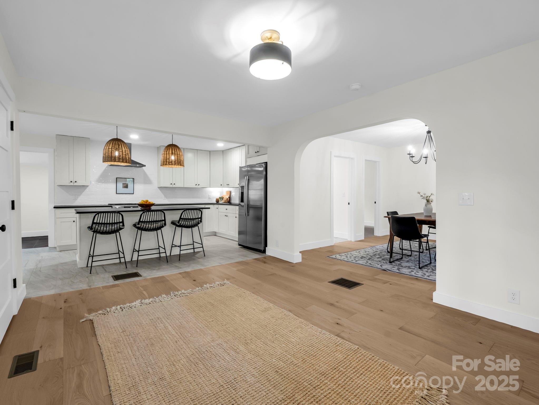 5990 South Nc 9 Highway Tryon, NC 28782 - Photo 28 of 42 a bedroom with a bed and a chandelier