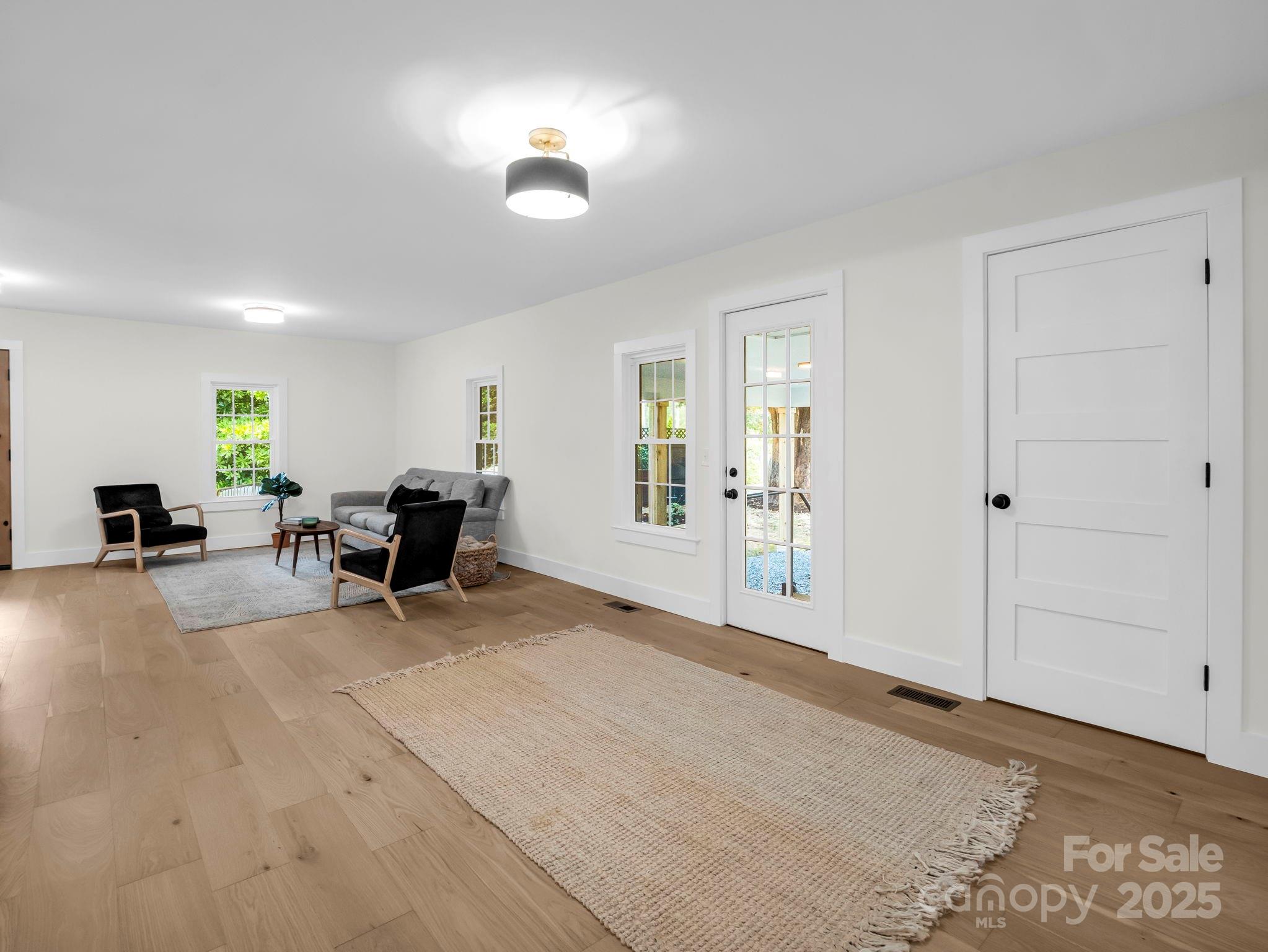 5990 South Nc 9 Highway Tryon, NC 28782 - Photo 31 of 42 a view of a livingroom with lounge chair and a window