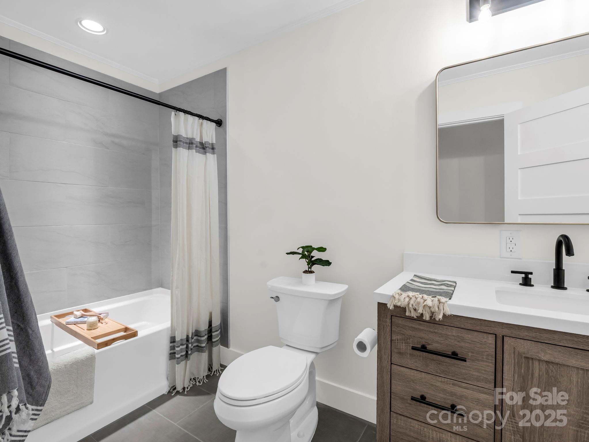 5990 South Nc 9 Highway Tryon, NC 28782 - Photo 32 of 42 a bathroom with a granite countertop toilet a sink and a mirror