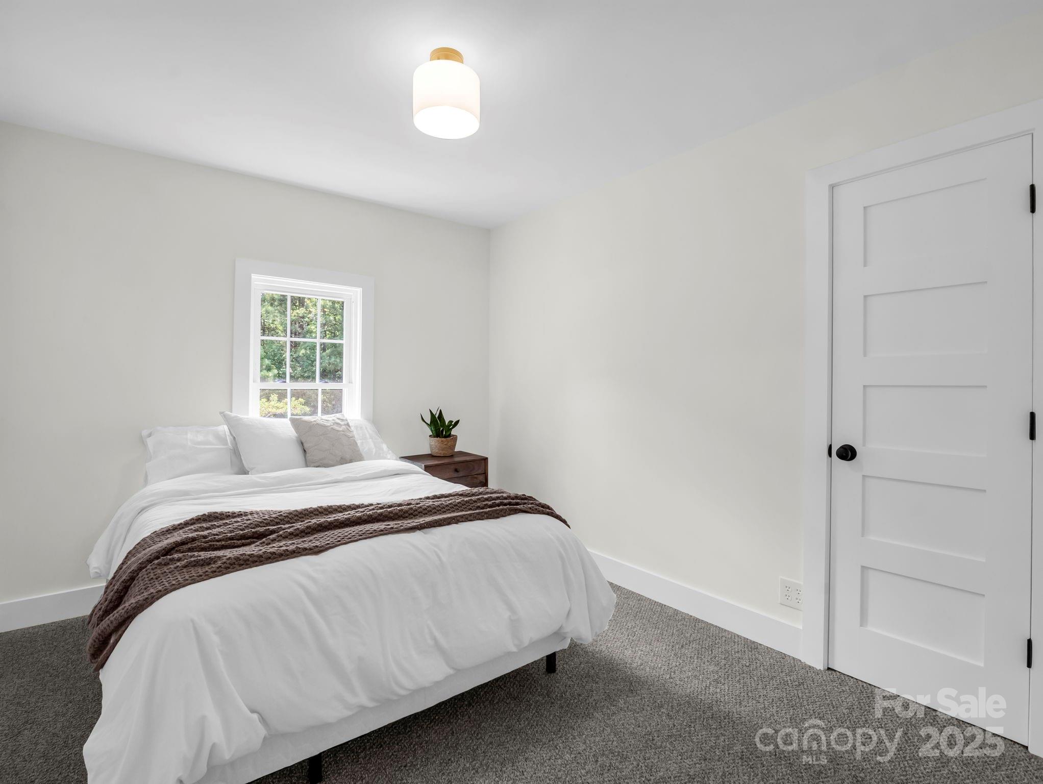 5990 South Nc 9 Highway Tryon, NC 28782 - Photo 33 of 42 a bedroom with a bed and a window