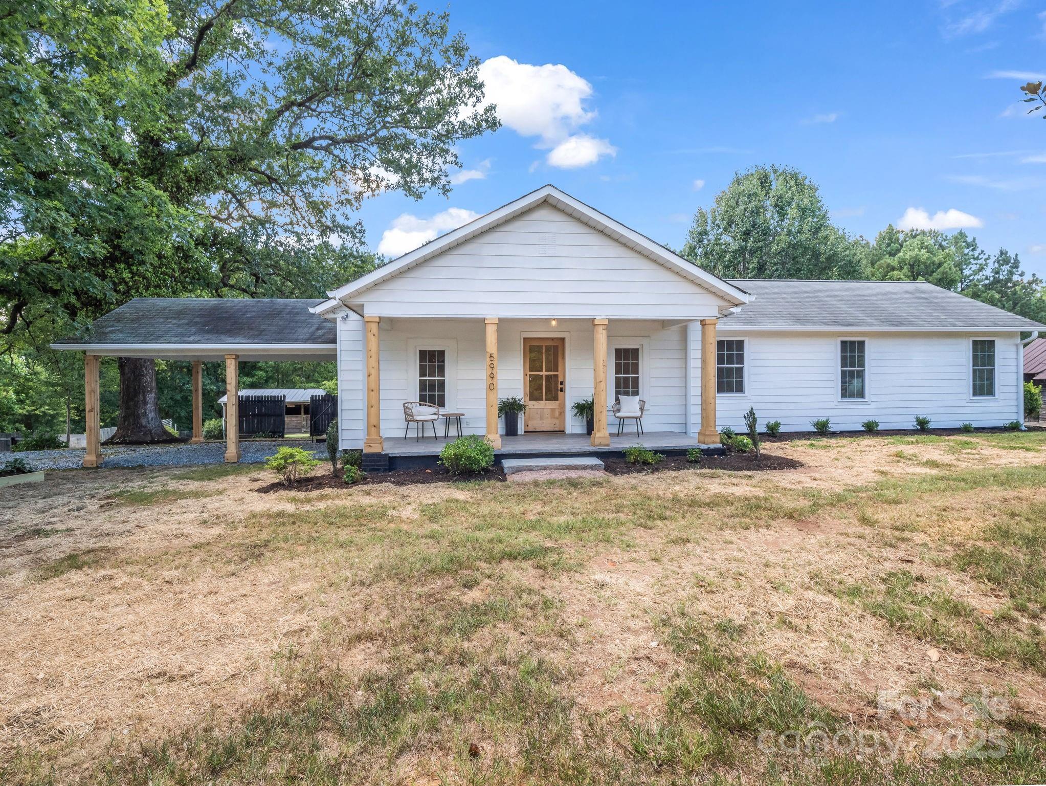 5990 South Nc 9 Highway Tryon, NC 28782 - Photo 40 of 42 a view of a house with a yard and potted plants