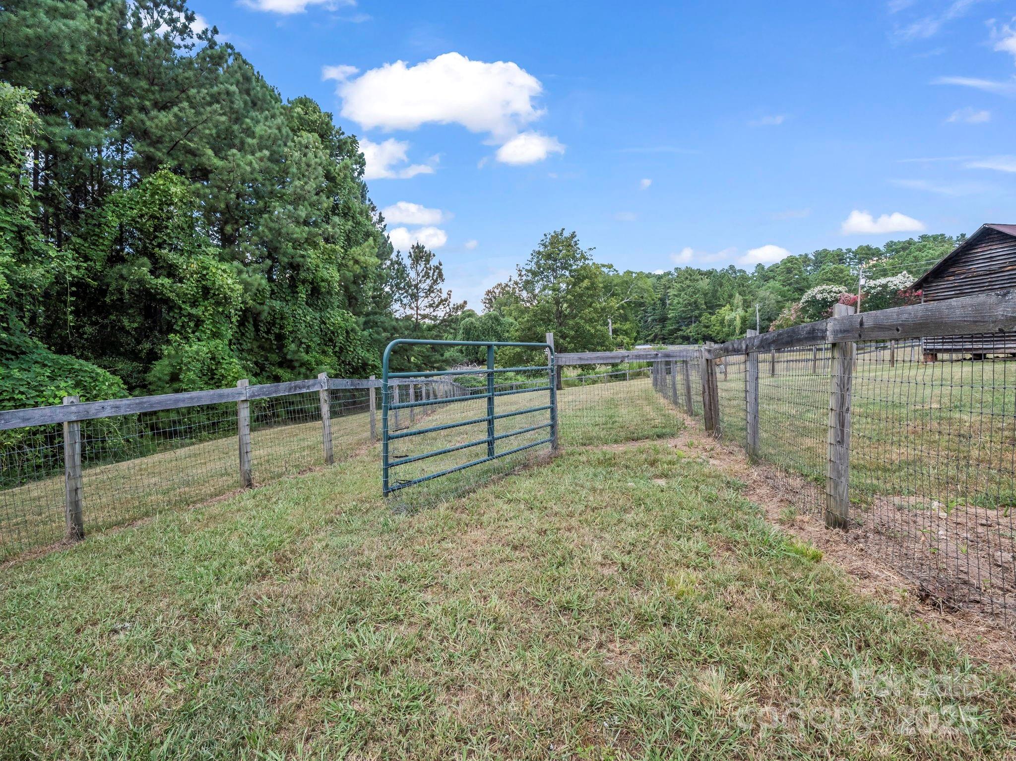 5990 South Nc 9 Highway Tryon, NC 28782 - Photo 5 of 42 a view of a yard with wooden fence