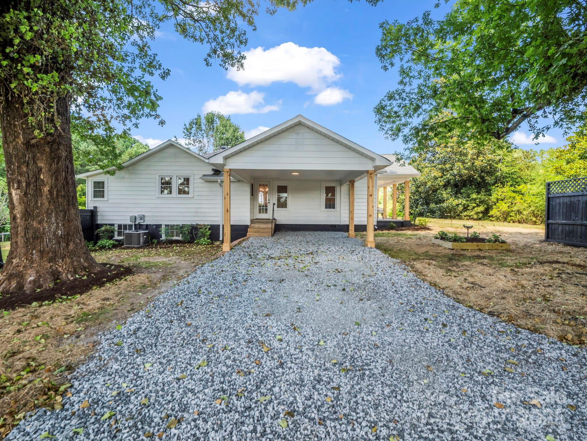 5990 South Nc 9 Highway Tryon, NC 28782 - Photo 7 of 42 a view of a house with a yard and large tree