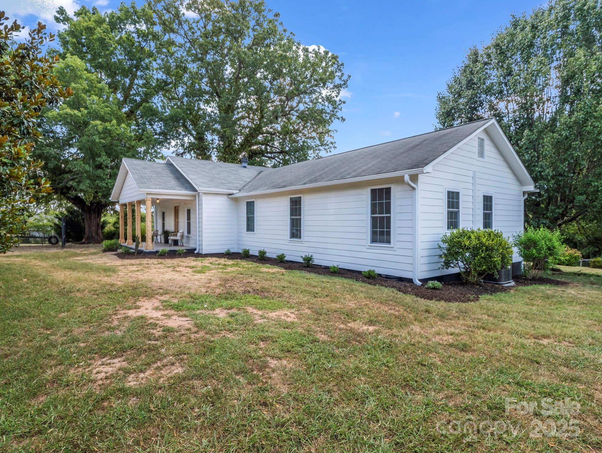 5990 South Nc 9 Highway Tryon, NC 28782 - Photo 8 of 42 a front view of a house with a garden