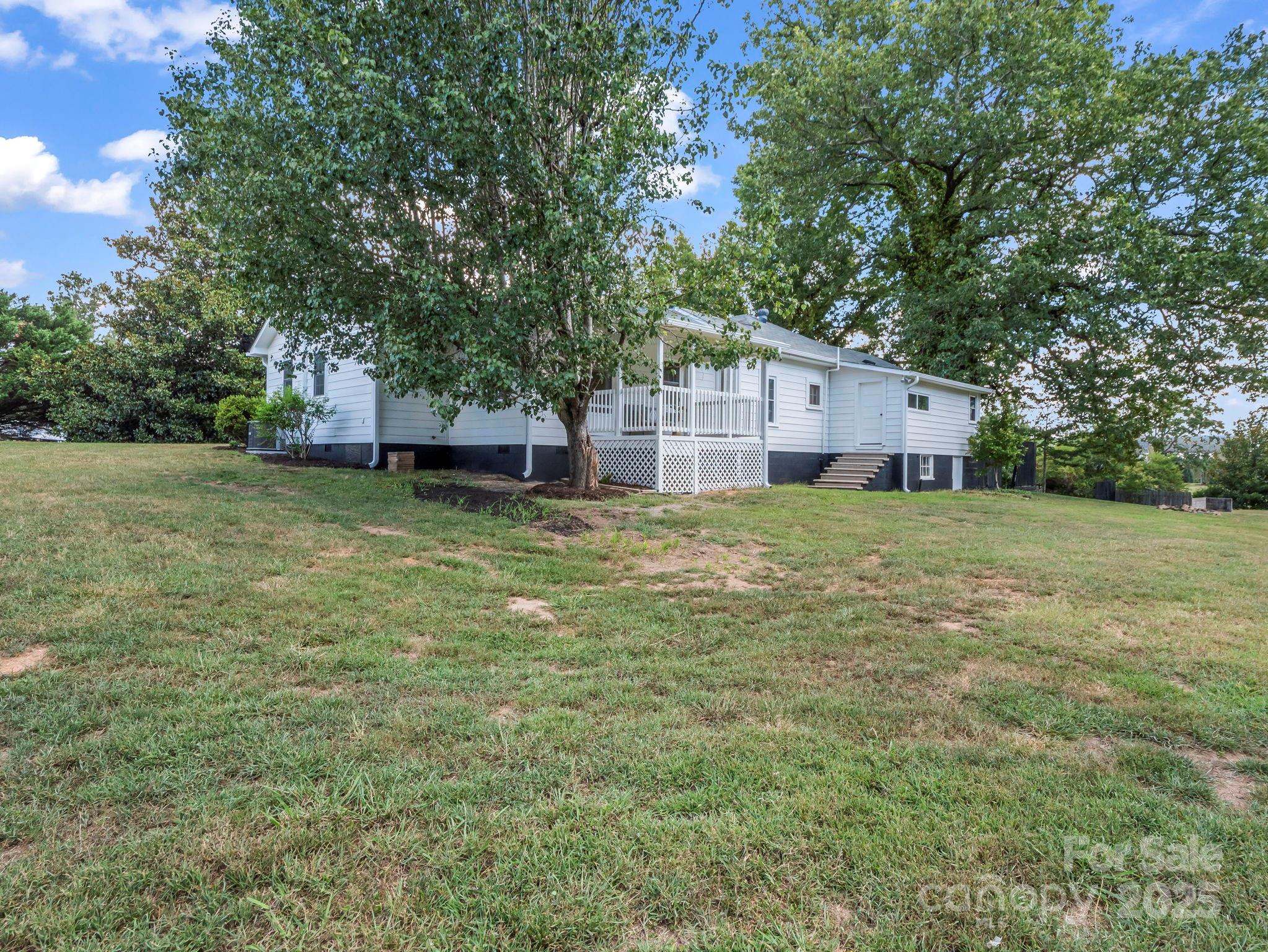 5990 South Nc 9 Highway Tryon, NC 28782 - Photo 9 of 42 a view of a house with a yard and a large tree