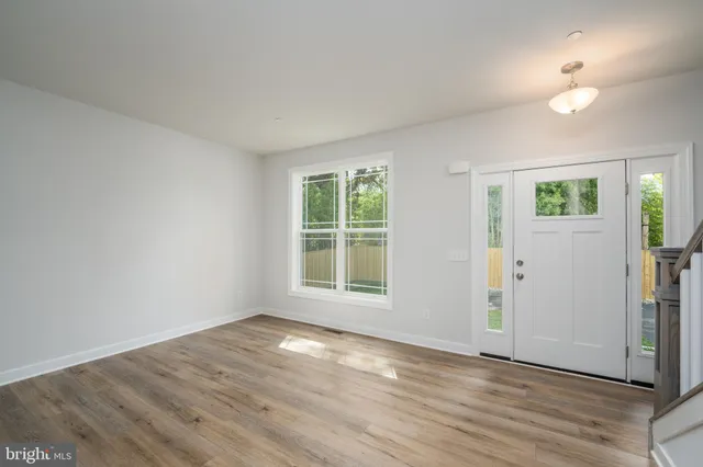 a view of a kitchen with wooden floor and a window