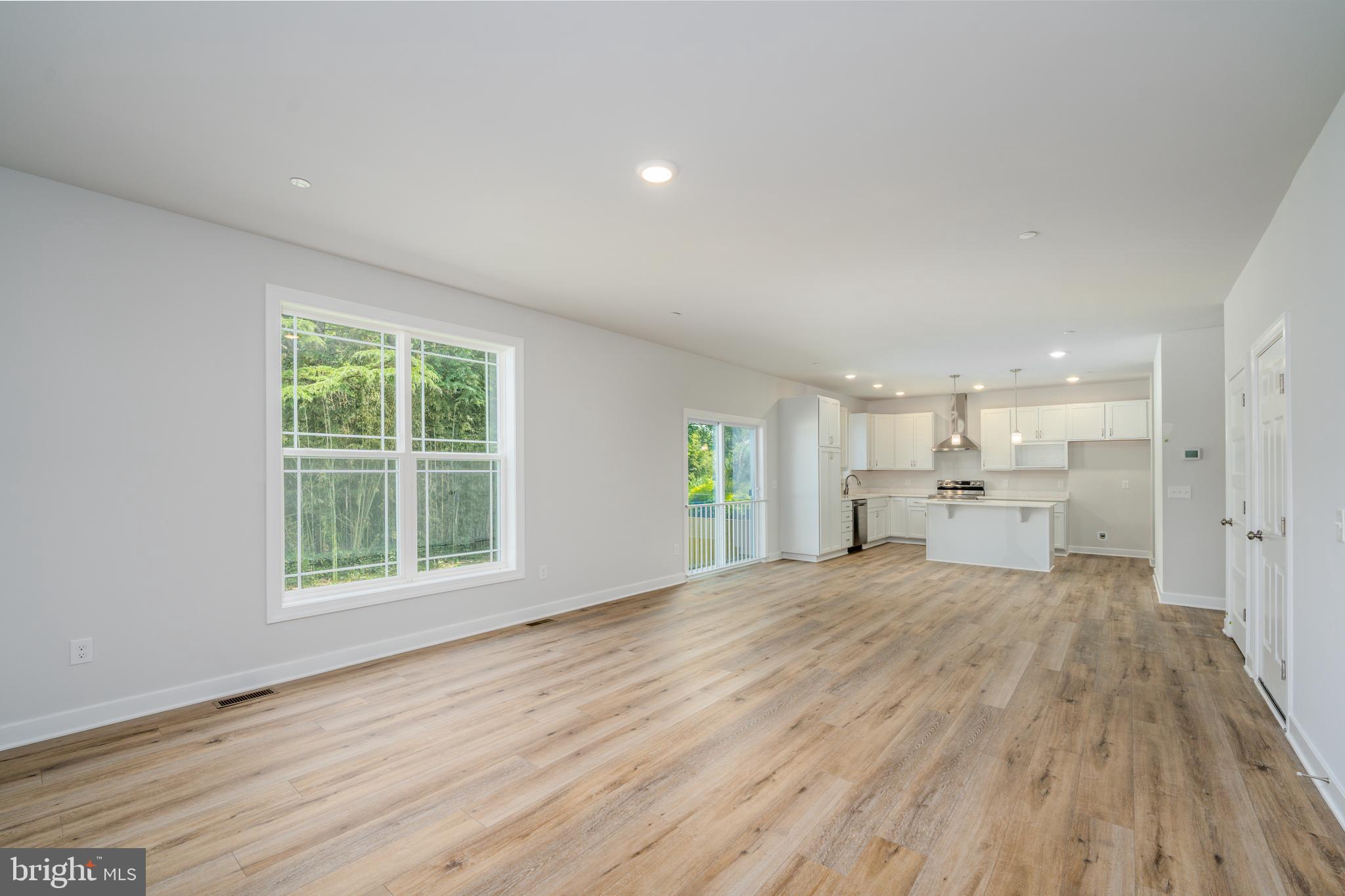 8118 Quarterfield Road Severn, MD 21144 - Photo 6 of 29 a view of a kitchen with wooden floor and a window