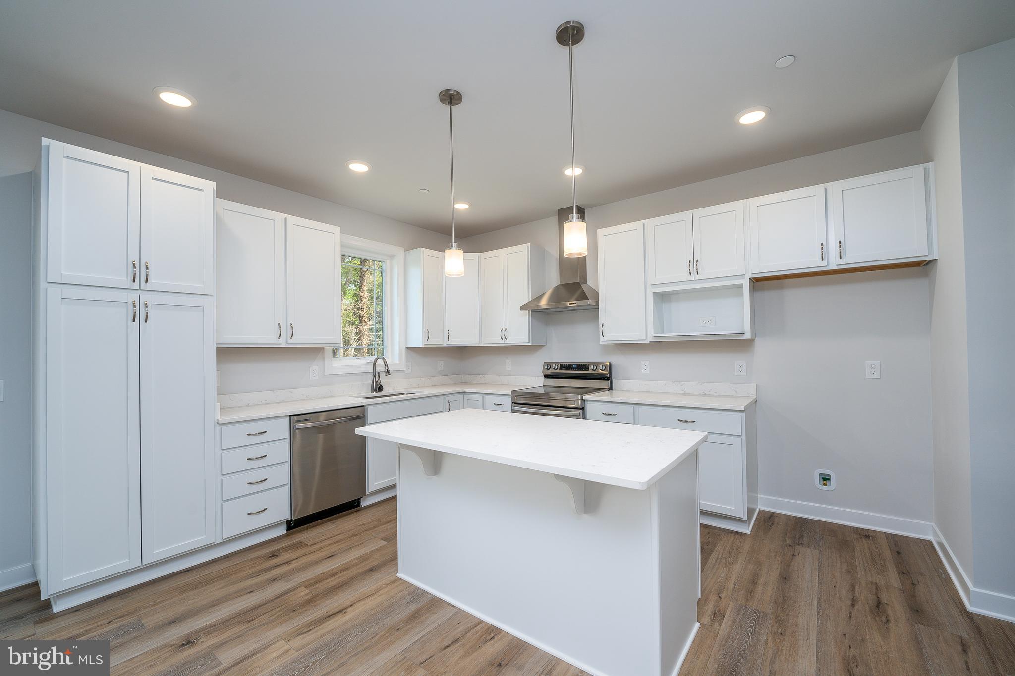 8118 Quarterfield Road Severn, MD 21144 - Photo 9 of 29 a large kitchen with stainless steel appliances granite countertop a sink a stove and a refrigerator