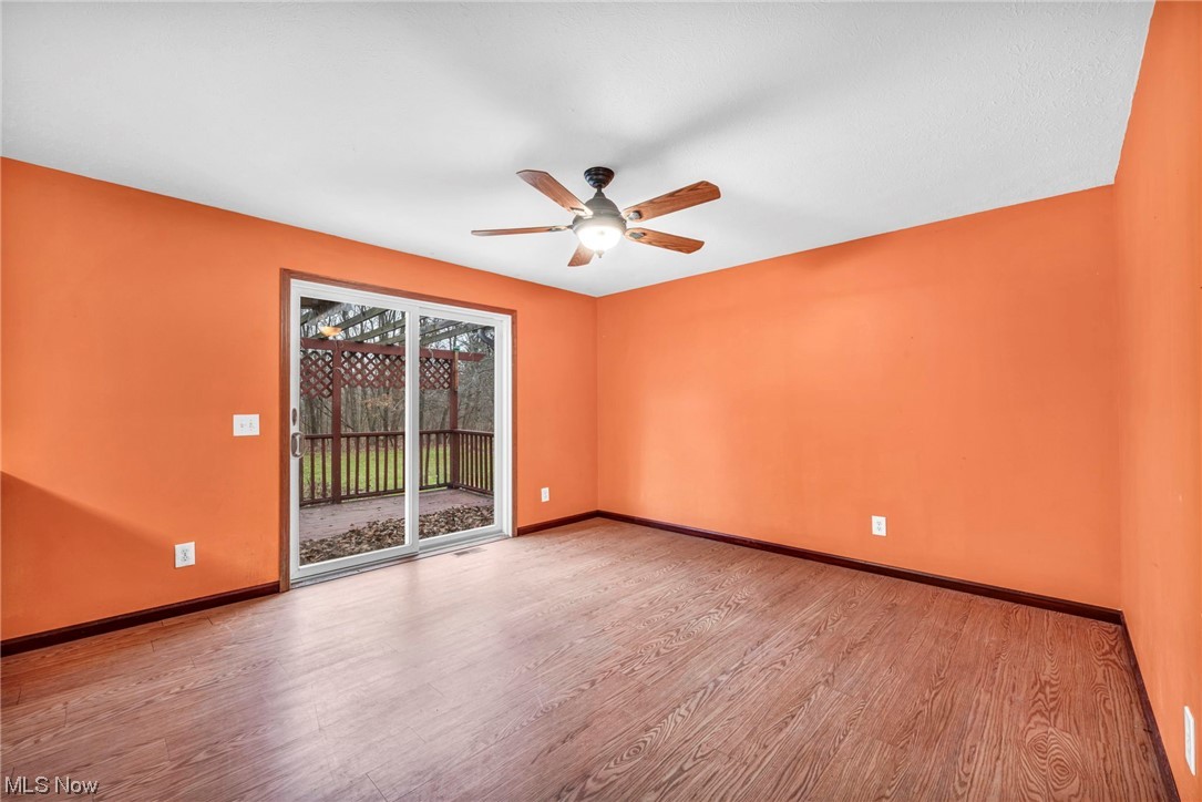 35808 Lorain Road North Ridgeville, OH 44039 - Photo 11 of 35 Empty room with ceiling fan and light wood-style floors