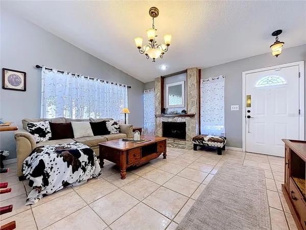 a living room with furniture and a table with wooden floor