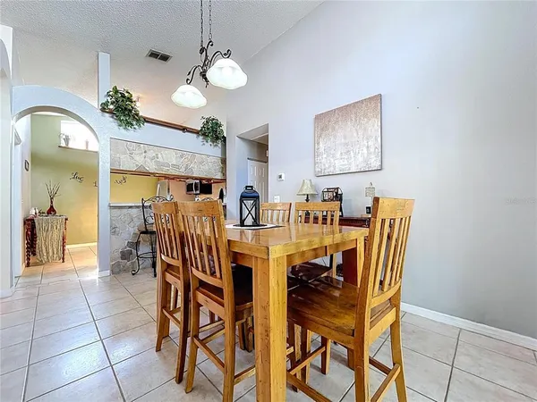 a view of a dining room with furniture and chandelier