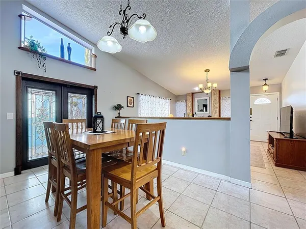 a view of a dining room with furniture and chandelier