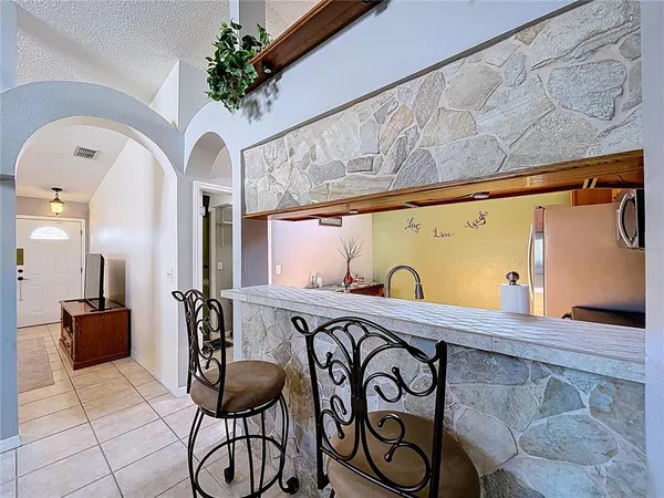 a view of a porch with chairs and entryway