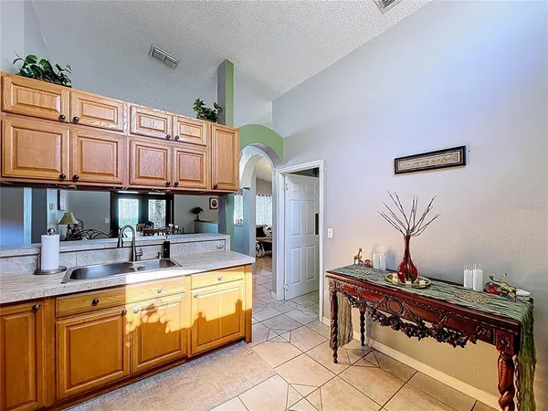 a kitchen with stainless steel appliances granite countertop a refrigerator a stove and a sink
