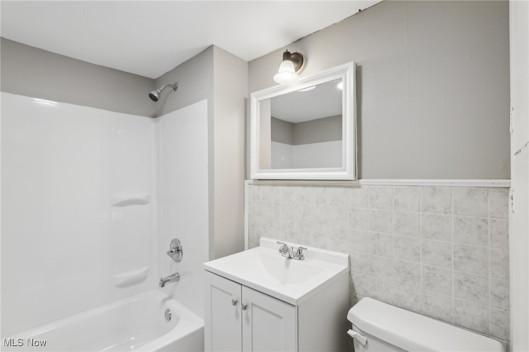 73 East York Street Akron, OH 44310 - Photo 28 of 36 Full bathroom with shower / bath combination, vanity, tile walls, and toilet