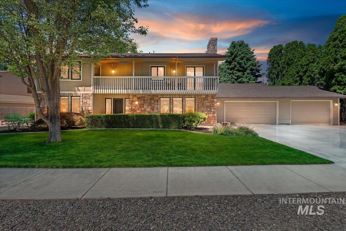 599 Pebble Beach Way Eagle, ID 83616 - Photo 1 of 44 Split-level residence featuring a stone facade and a second-story balcony with white railing
