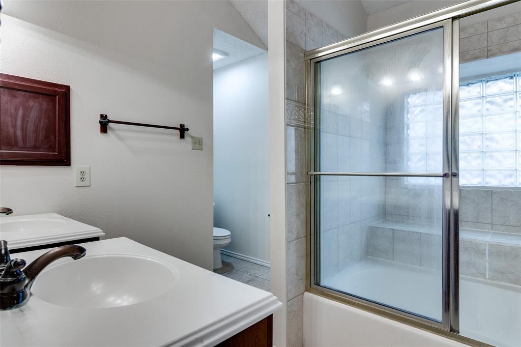 4106 Countryside Drive Grapevine, TX 76051 - Photo 3 of 10 a bathroom with a sink and a mirror