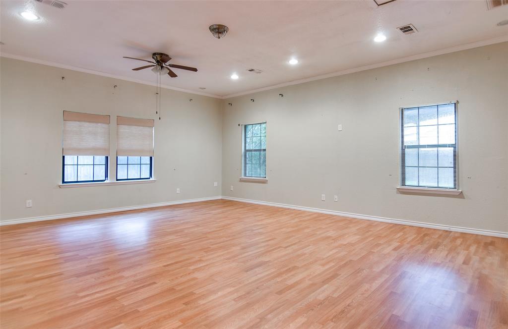 4106 Countryside Drive Grapevine, TX 76051 - Photo 6 of 10 a view of an empty room with window and wooden floor