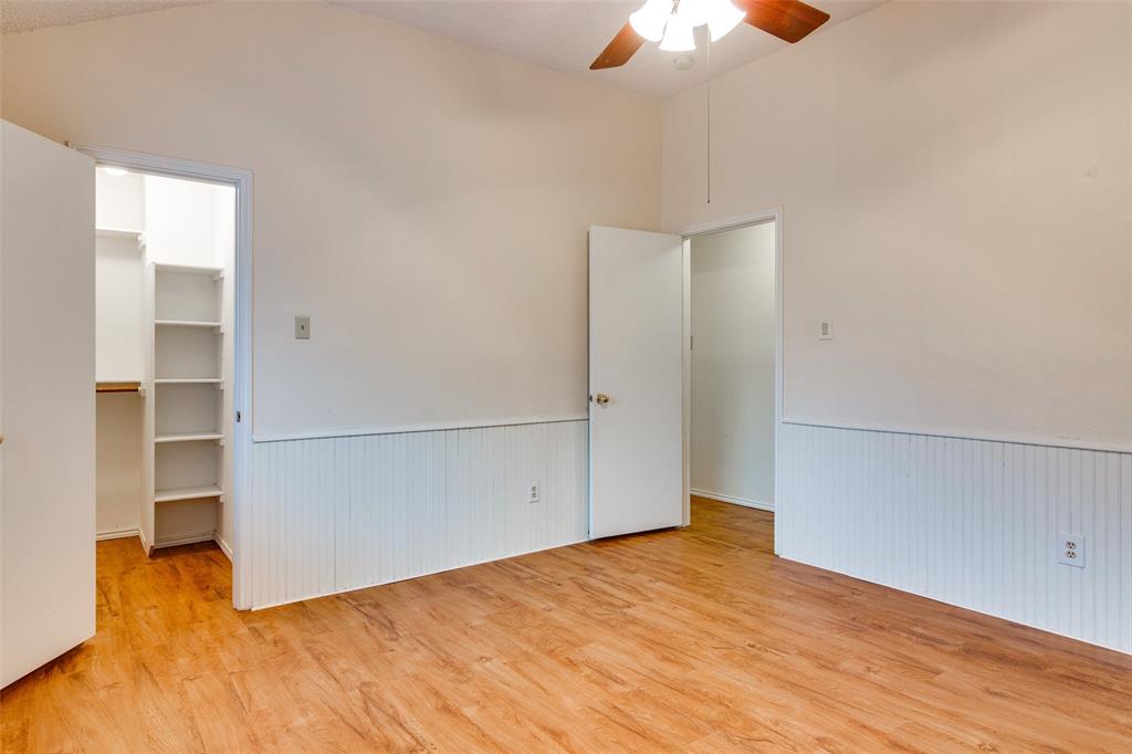 4106 Countryside Drive Grapevine, TX 76051 - Photo 9 of 10 an empty room with closet and a chandelier fan