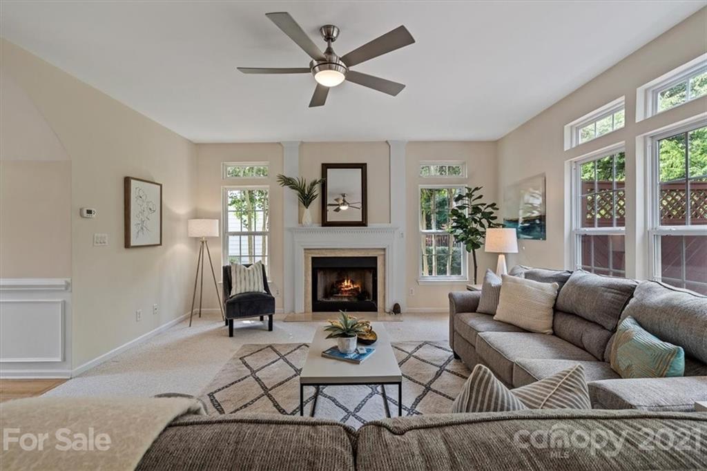 6616 Elfreda Road Charlotte, NC 28270 - Photo 11 of 37 a living room with furniture a fireplace and a large window