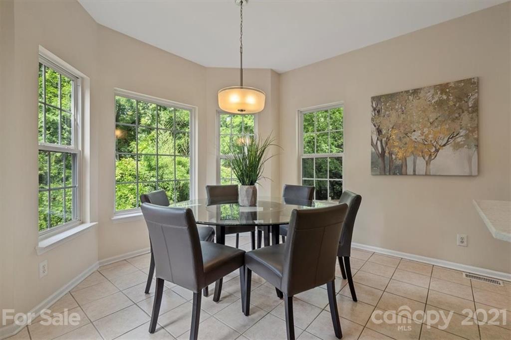 6616 Elfreda Road Charlotte, NC 28270 - Photo 13 of 37 a dining room with furniture a chandelier and wooden floor