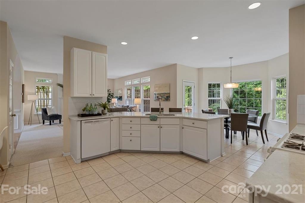 6616 Elfreda Road Charlotte, NC 28270 - Photo 18 of 37 a kitchen with sink and chairs