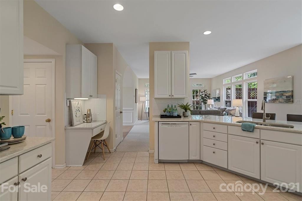 6616 Elfreda Road Charlotte, NC 28270 - Photo 19 of 37 a kitchen with white cabinets a sink and appliances
