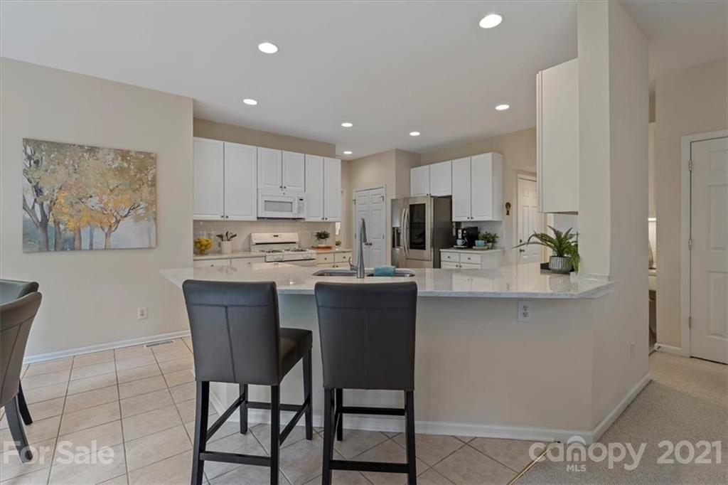6616 Elfreda Road Charlotte, NC 28270 - Photo 21 of 37 a kitchen with kitchen island granite countertop wooden cabinets and counter space