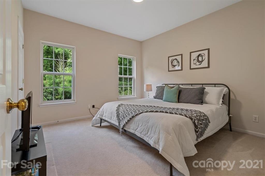 6616 Elfreda Road Charlotte, NC 28270 - Photo 22 of 37 a spacious bedroom with a bed and a window