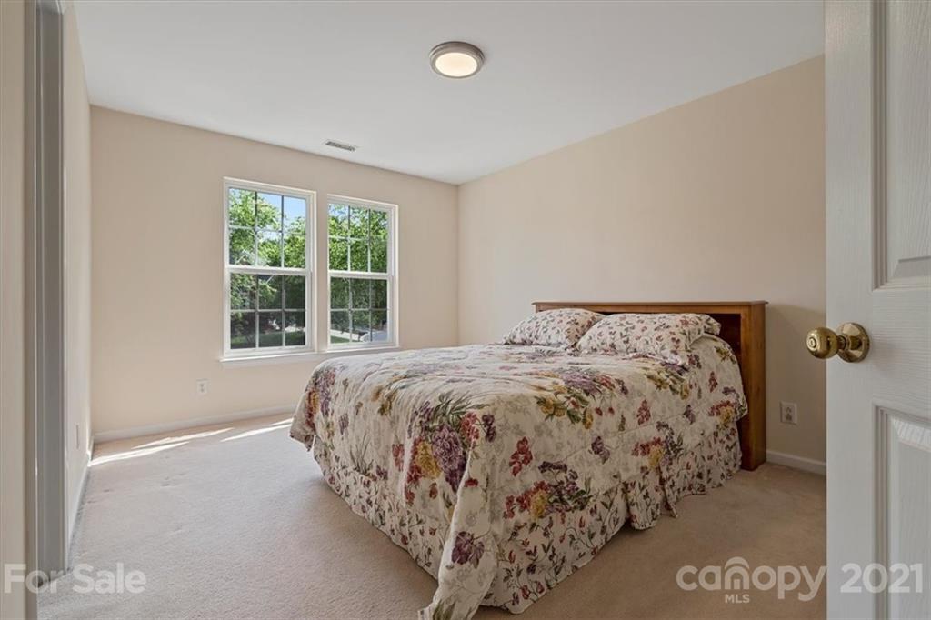 6616 Elfreda Road Charlotte, NC 28270 - Photo 24 of 37 a bed sitting in a bedroom next to a window