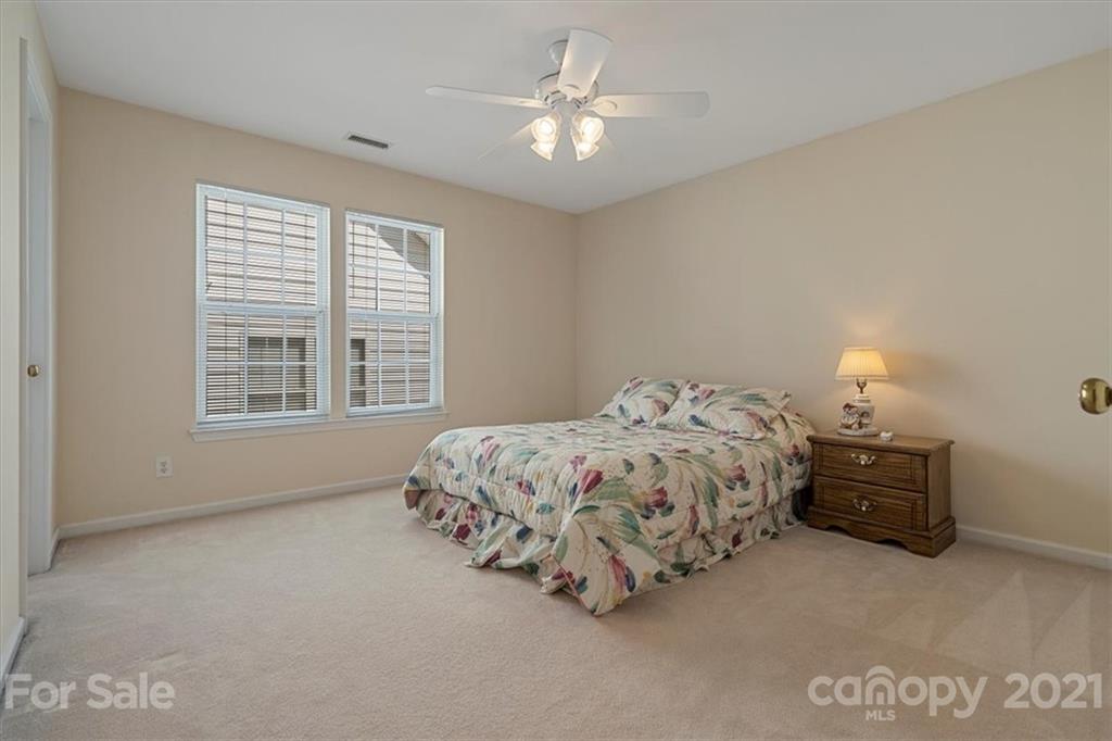 6616 Elfreda Road Charlotte, NC 28270 - Photo 27 of 37 a bed sitting in a bedroom next to a window