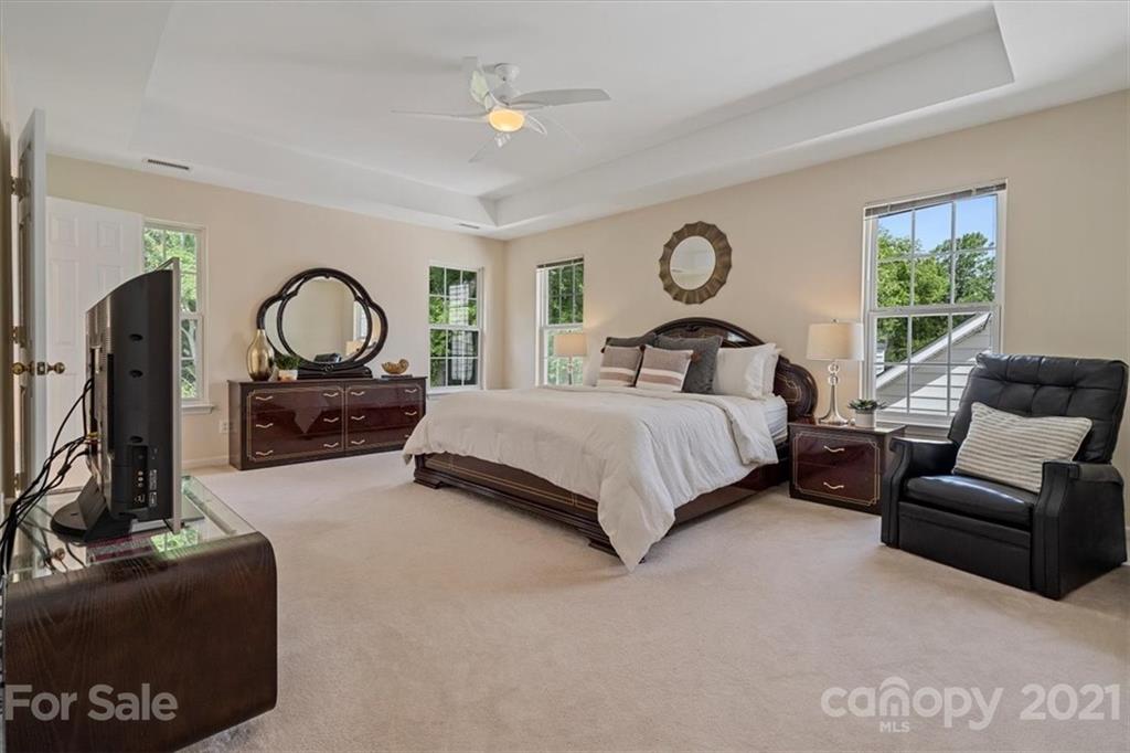 6616 Elfreda Road Charlotte, NC 28270 - Photo 29 of 37 a bedroom with a bed a couch and dresser