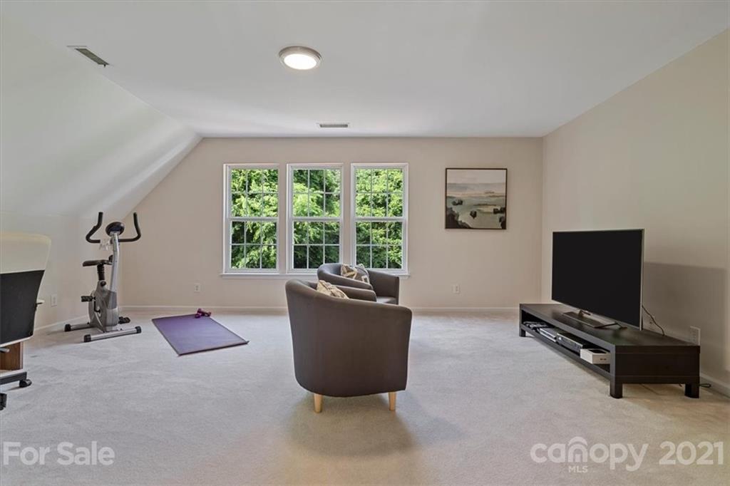 6616 Elfreda Road Charlotte, NC 28270 - Photo 32 of 37 a living room with furniture and a flat screen tv