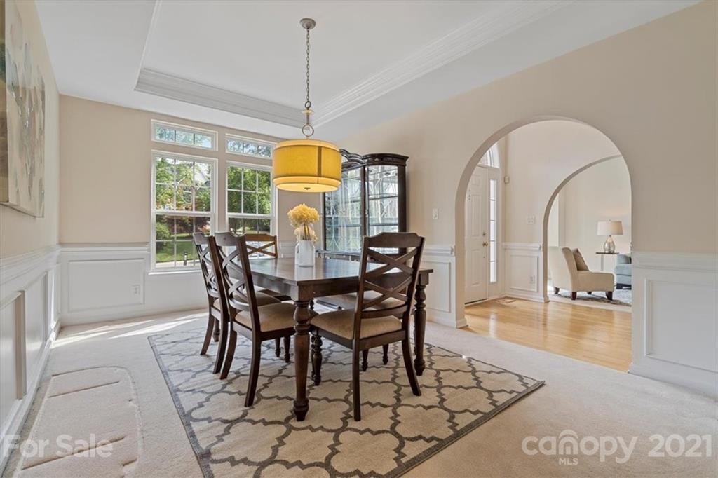 6616 Elfreda Road Charlotte, NC 28270 - Photo 5 of 37 a dining room with furniture a chandelier and wooden floor