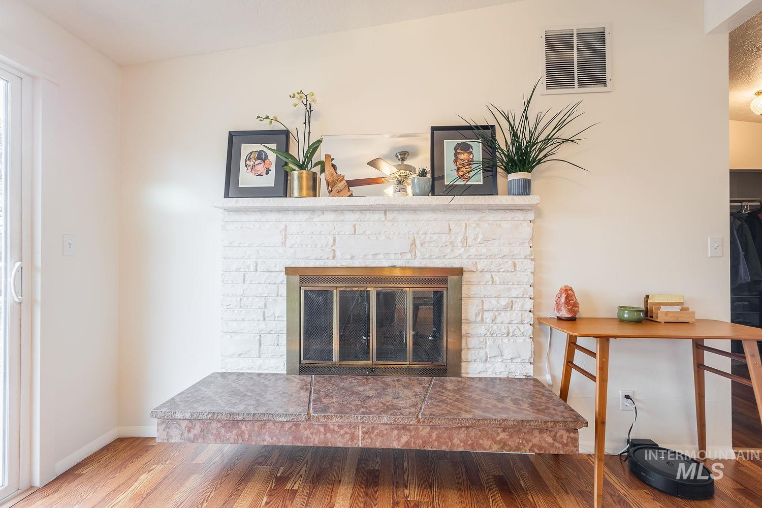 6403 Colonial Drive Boise, ID 83709 - Photo 13 of 42 Detailed view of a glass covered fireplace and wood finished floors
