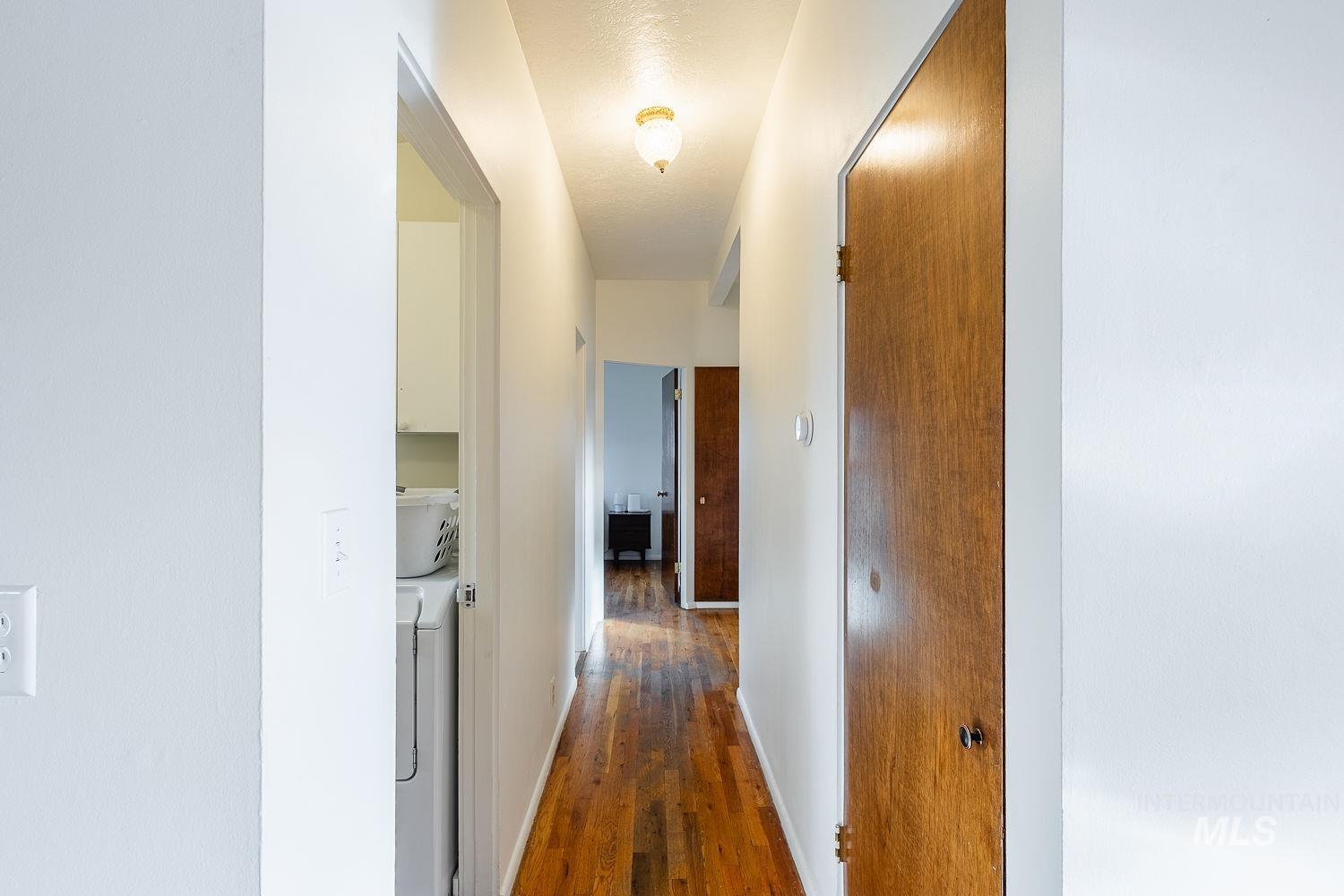 6403 Colonial Drive Boise, ID 83709 - Photo 20 of 42 Corridor featuring dark wood-style floors and baseboards