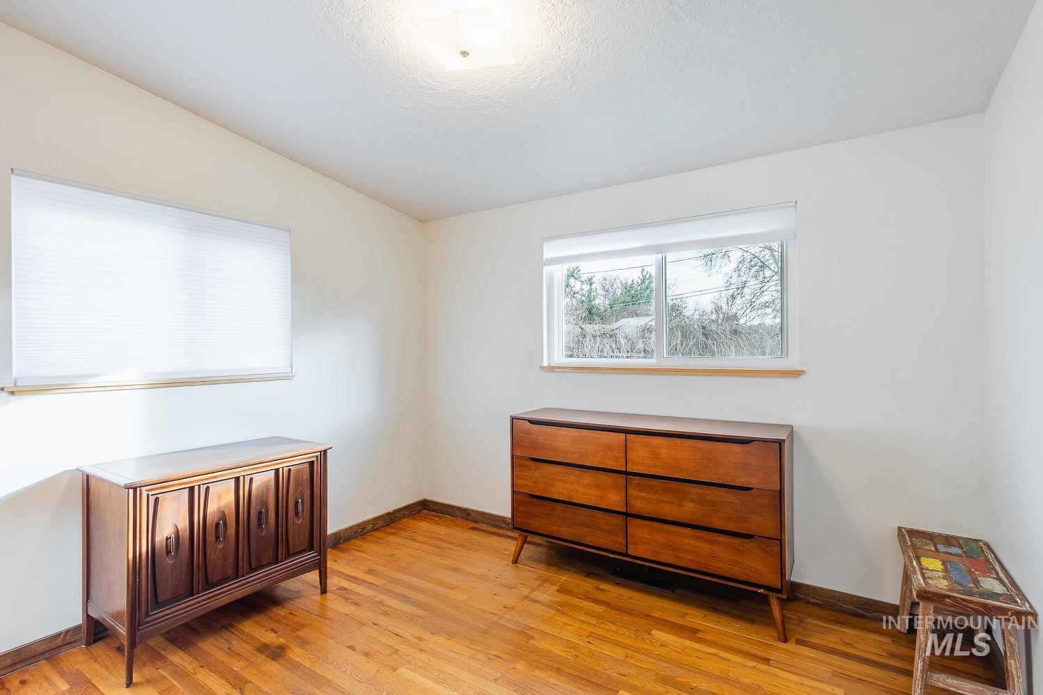 6403 Colonial Drive Boise, ID 83709 - Photo 21 of 42 Bedroom with lofted ceiling, light wood-style flooring, and a textured ceiling