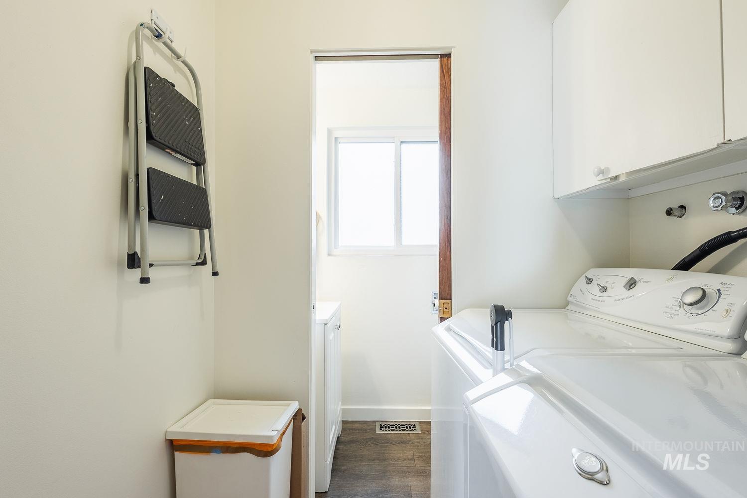 6403 Colonial Drive Boise, ID 83709 - Photo 29 of 42 Laundry room with dark wood-style flooring, cabinet space, and washer and dryer