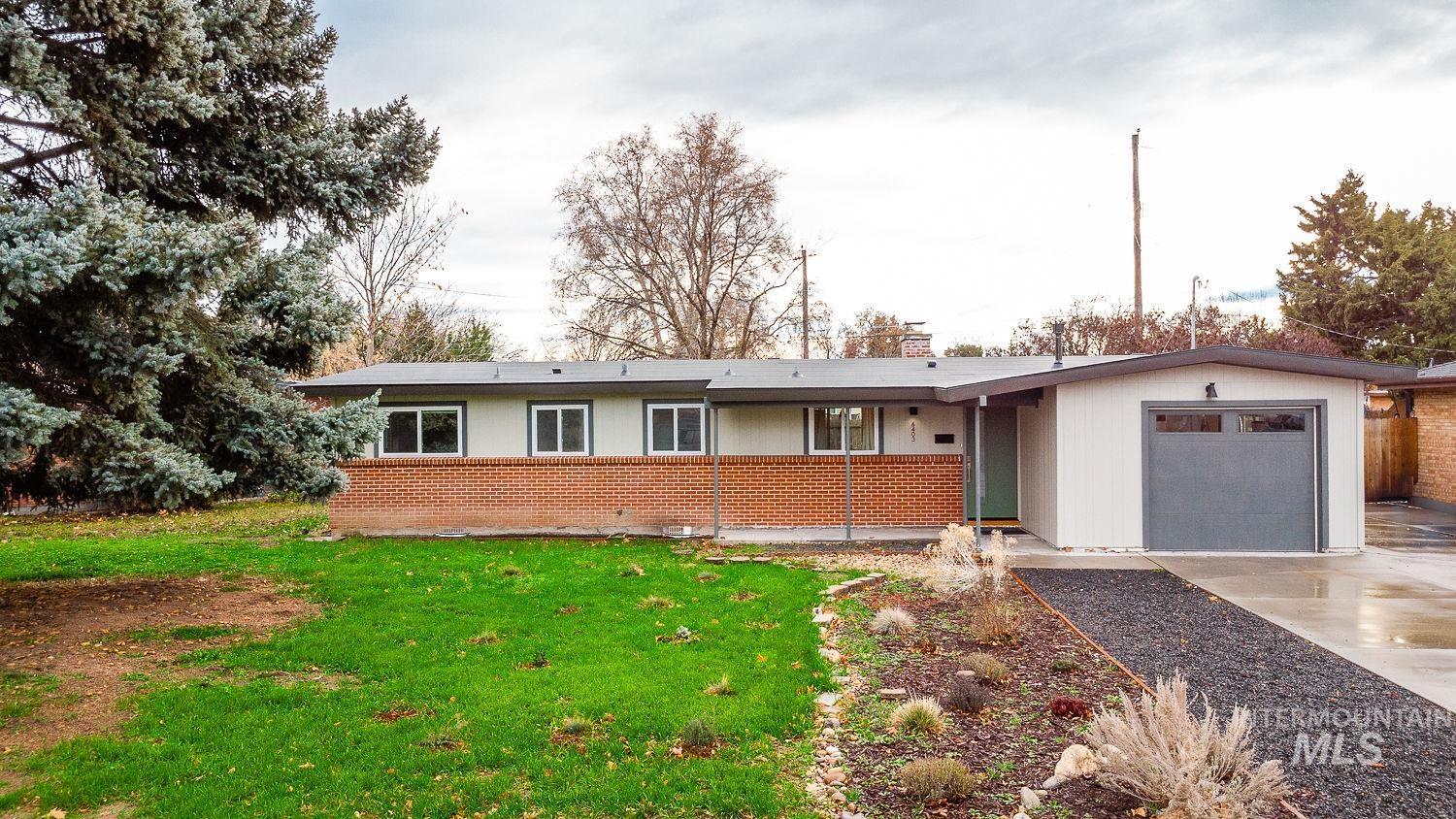 6403 Colonial Drive Boise, ID 83709 - Photo 41 of 42 Ranch-style home with a front yard, brick siding, driveway, an attached garage, and a chimney