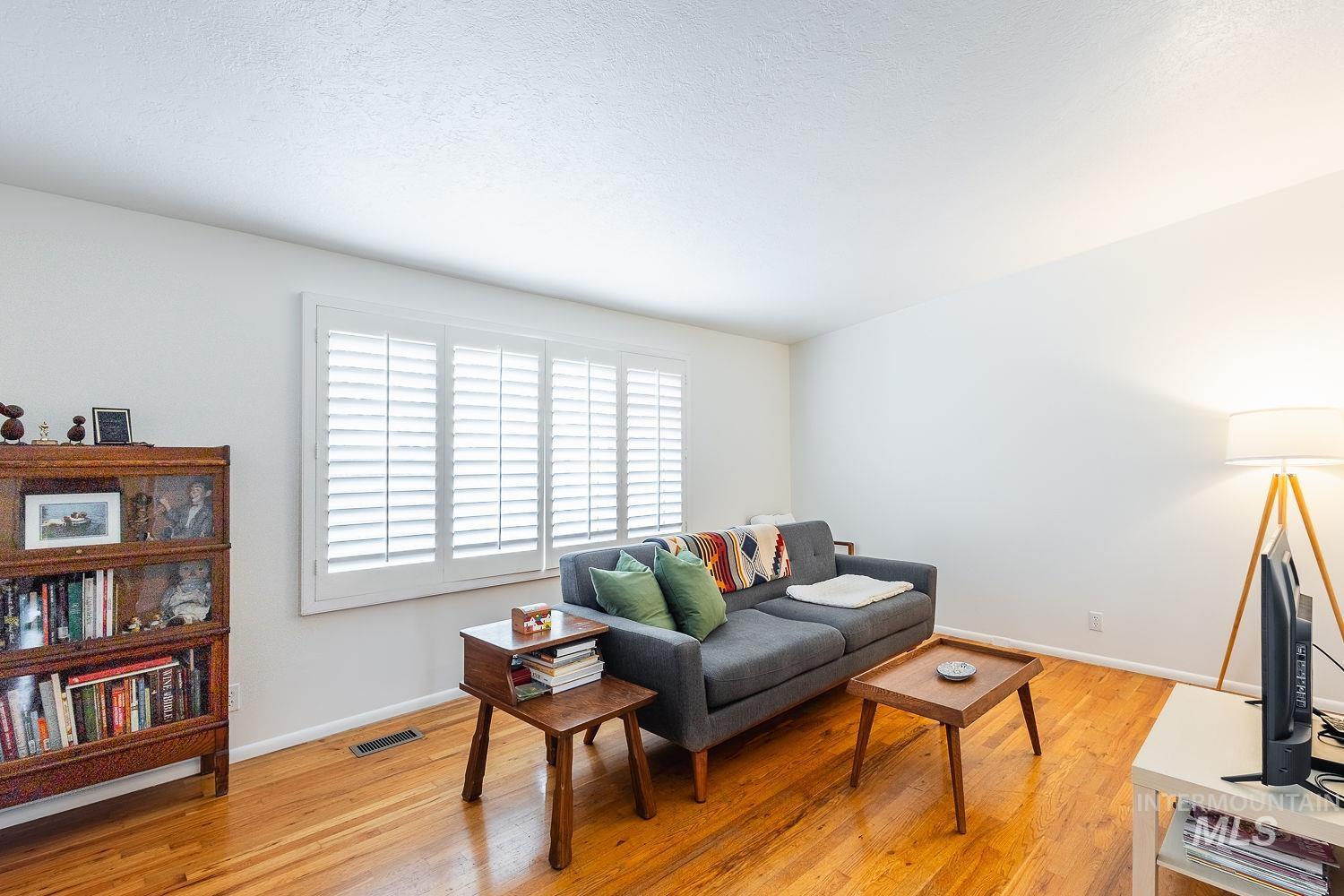 6403 Colonial Drive Boise, ID 83709 - Photo 6 of 42 Living area with light wood-type flooring and a textured ceiling