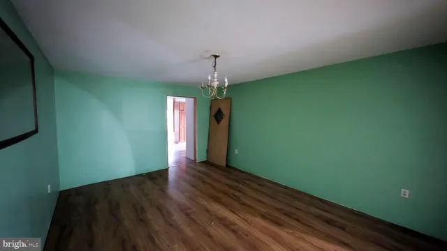 a view of a room with wooden floor and windows