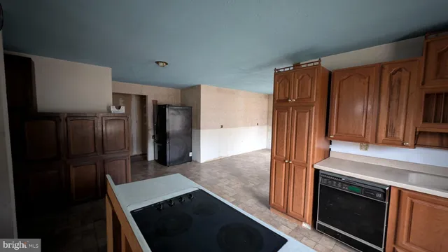 a kitchen with stainless steel appliances a refrigerator and a stove top oven