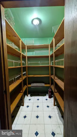 an empty room with windows and cabinet