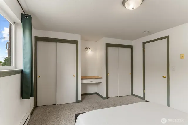 a spacious bedroom with a bed and a lamp