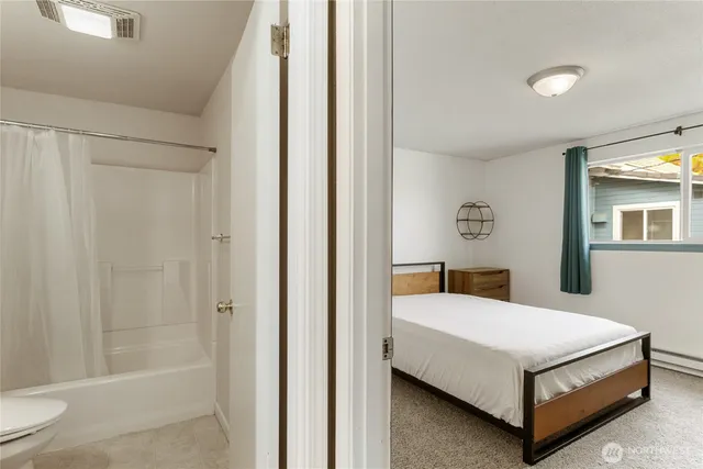 a bedroom with a bed and a table in it