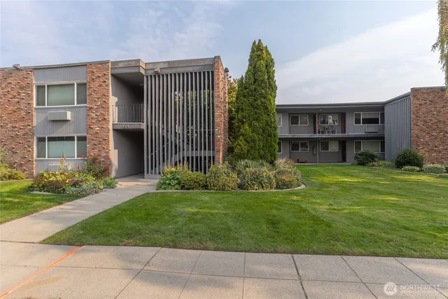 a view of a house with a yard and sitting area